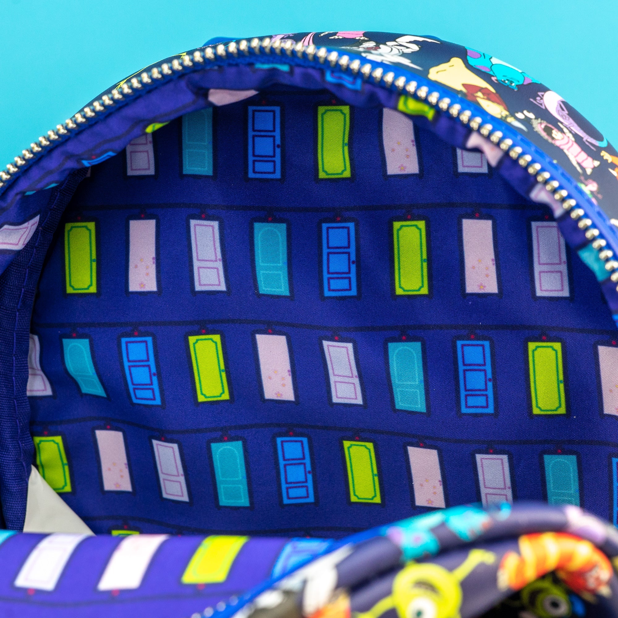 Loungefly x Disney Pixar Monsters Inc AOP Mini Backpack - GeekCore
